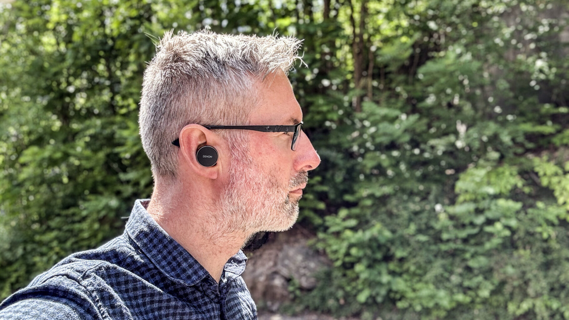 a man wearing glasses and a wireless earbuds Denon PerL Pro - GeirNordby